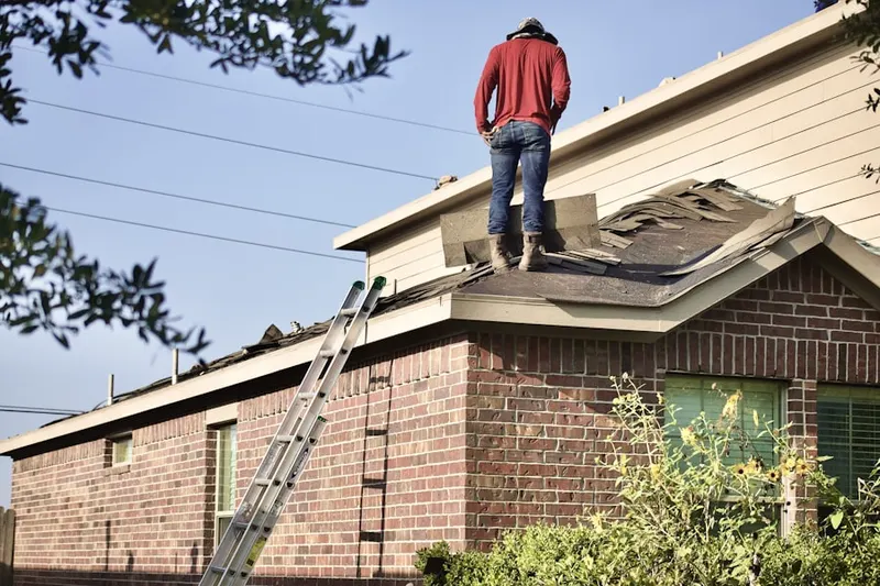 Professional roofer working on a residential roof in Riverview Manor